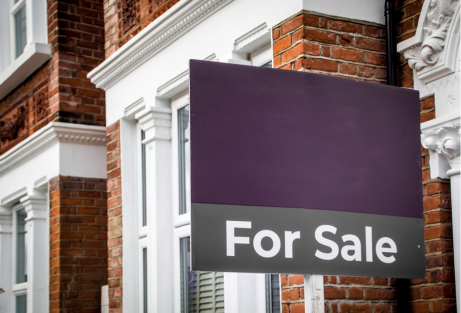 Purple for sale sign outside a home