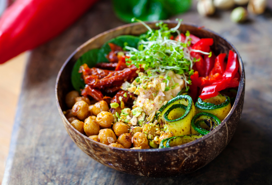 A vegan Buddha bowl with chickpeas, courgettes, tomatoes and sprouts