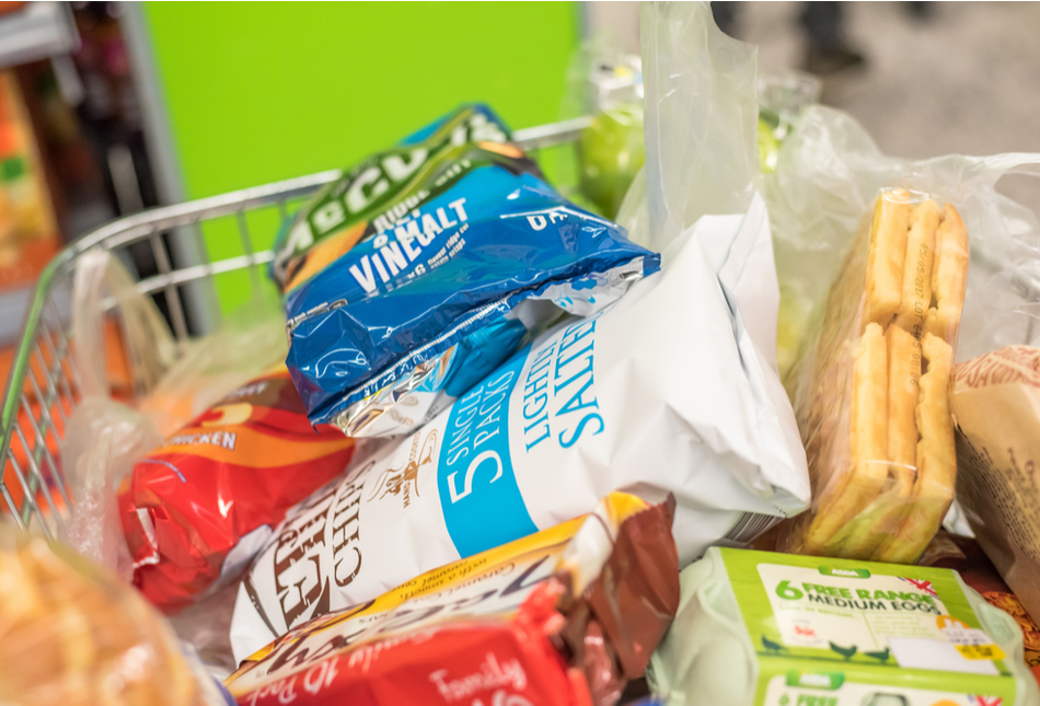 A supermarket trolley filled with groceries.