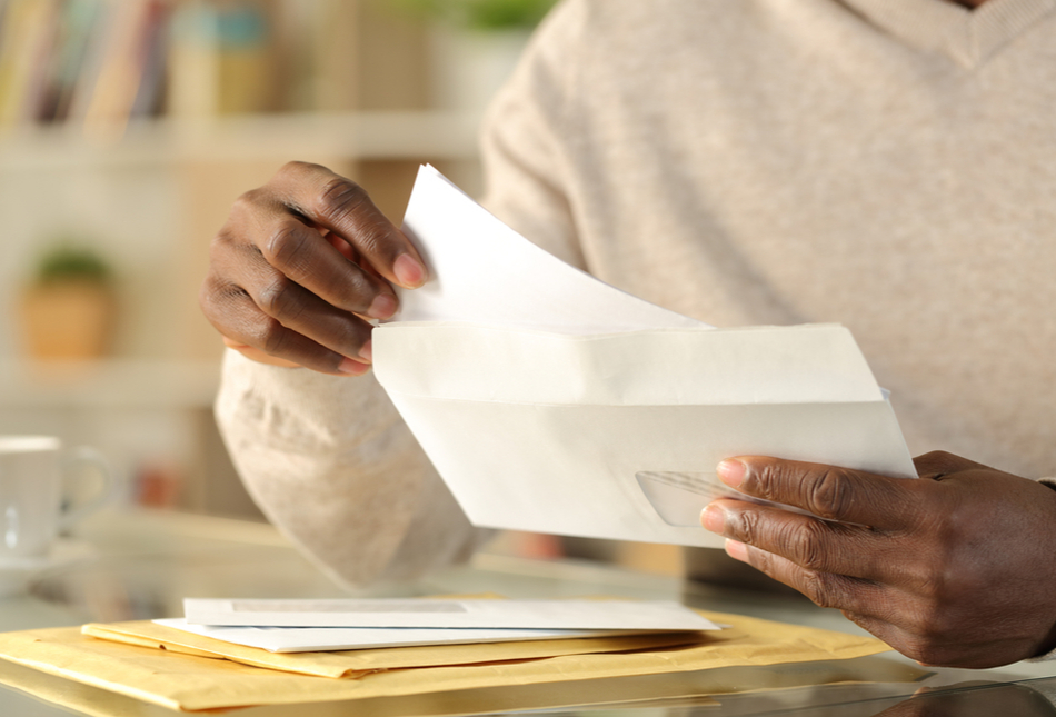 A man opening a letter.