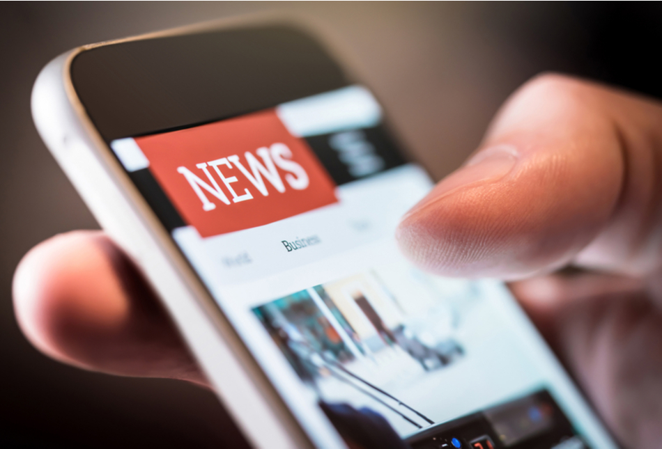 Someone reading the news on their phone.