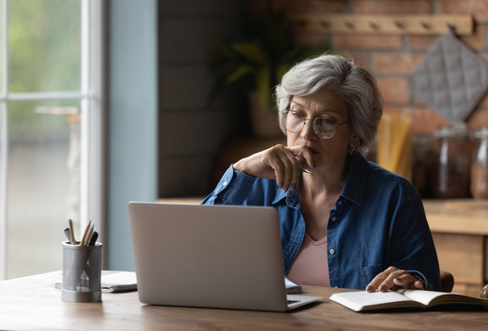 A woman sitting at a table with a laptop