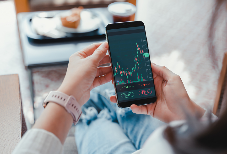 A woman checking investment performance on a phone.