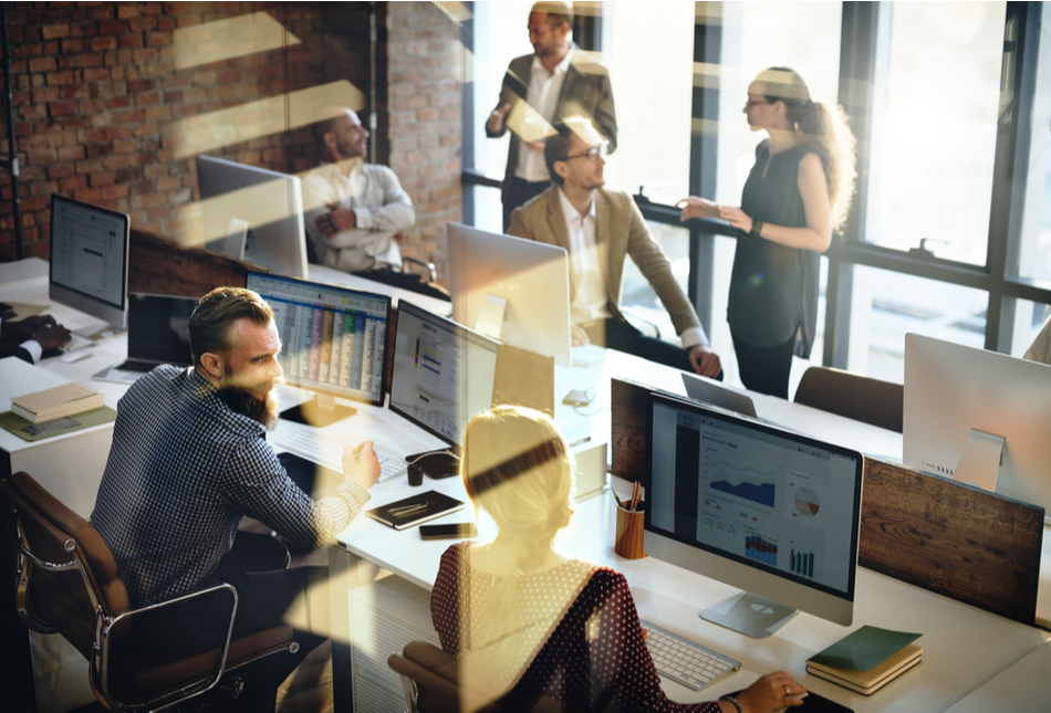 Workers in an open-plan office.