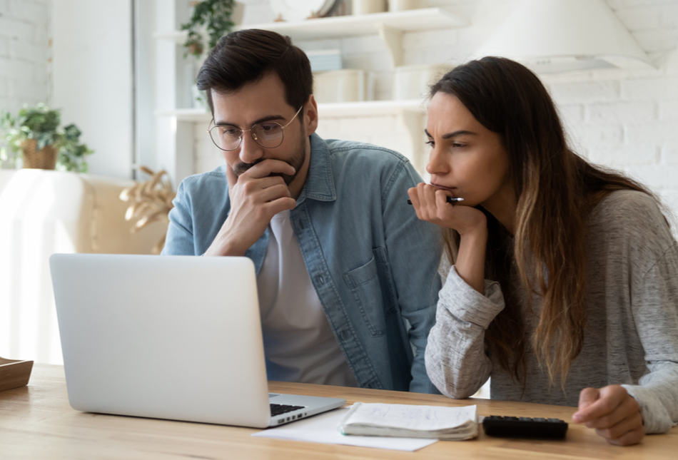 A couple looking at a laptop.