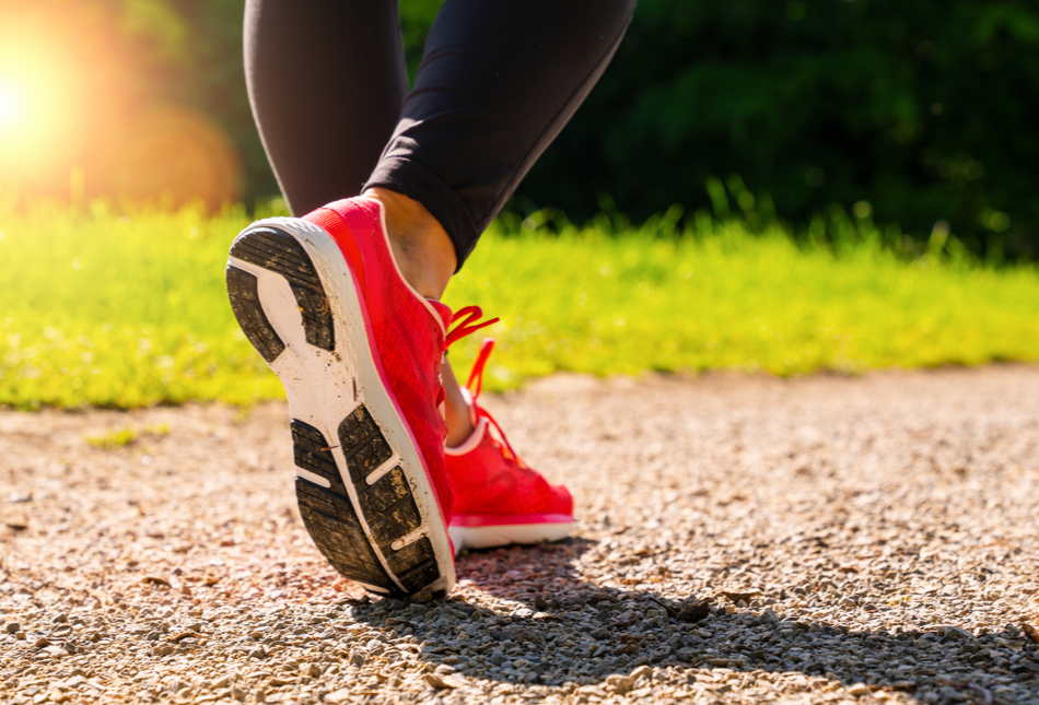 A person walking in running shoes in summer.