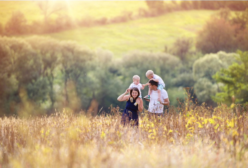 A family walking through a field in spring time.