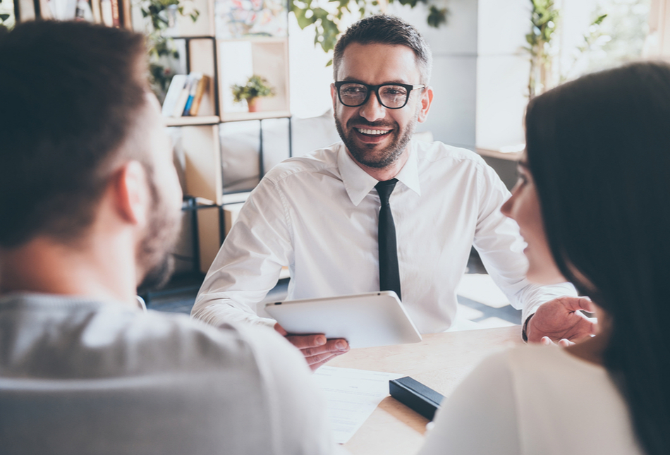 A couple in a meeting with a financial adviser.