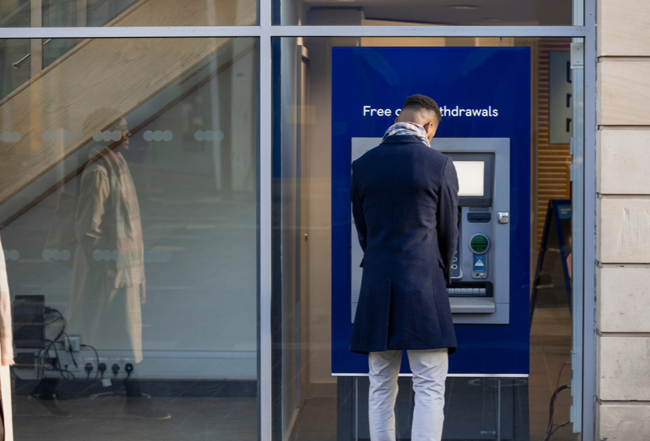 A man withdrawing money from an ATM.