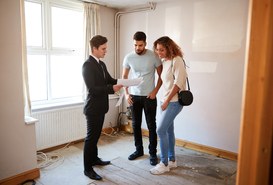 A young couple viewing an empty property.