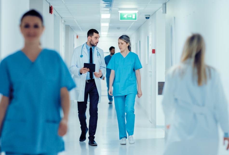 Doctors walking down a hospital corridor.