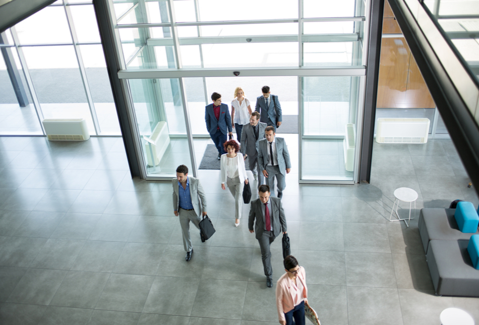 Business people walking into an office building.