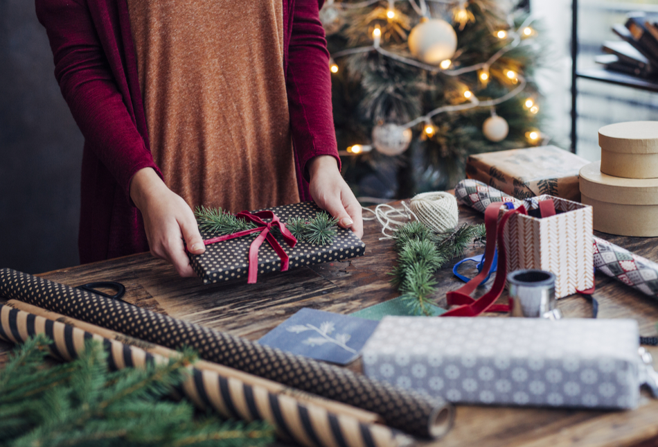 A woman wrapping Christmas presents.