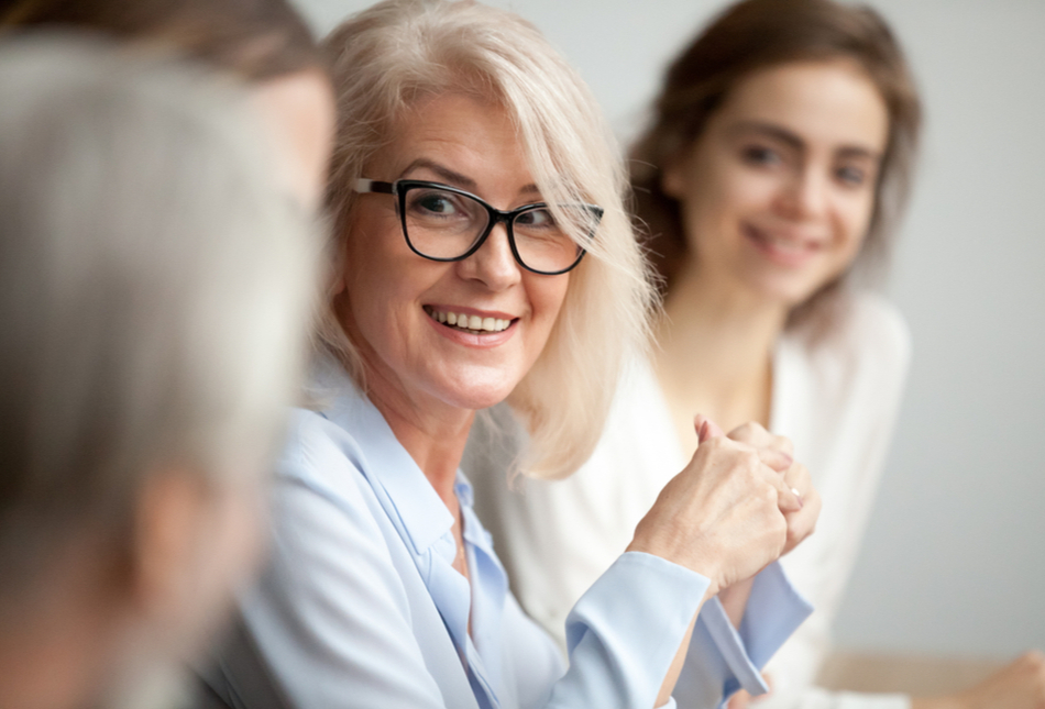 A businesswoman smiling with colleagues.
