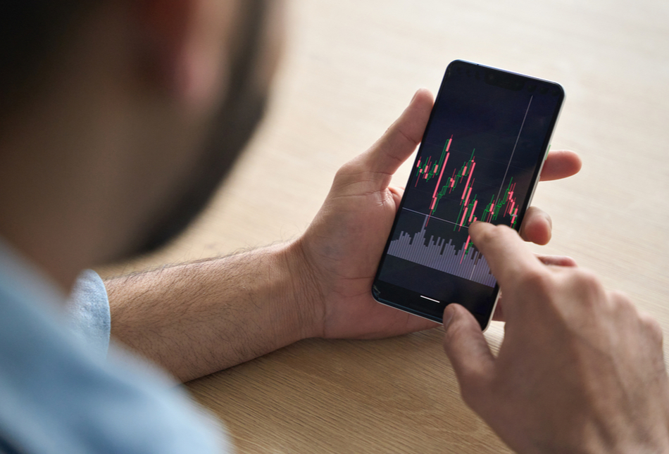 Someone looking at stock market performance on their phone.