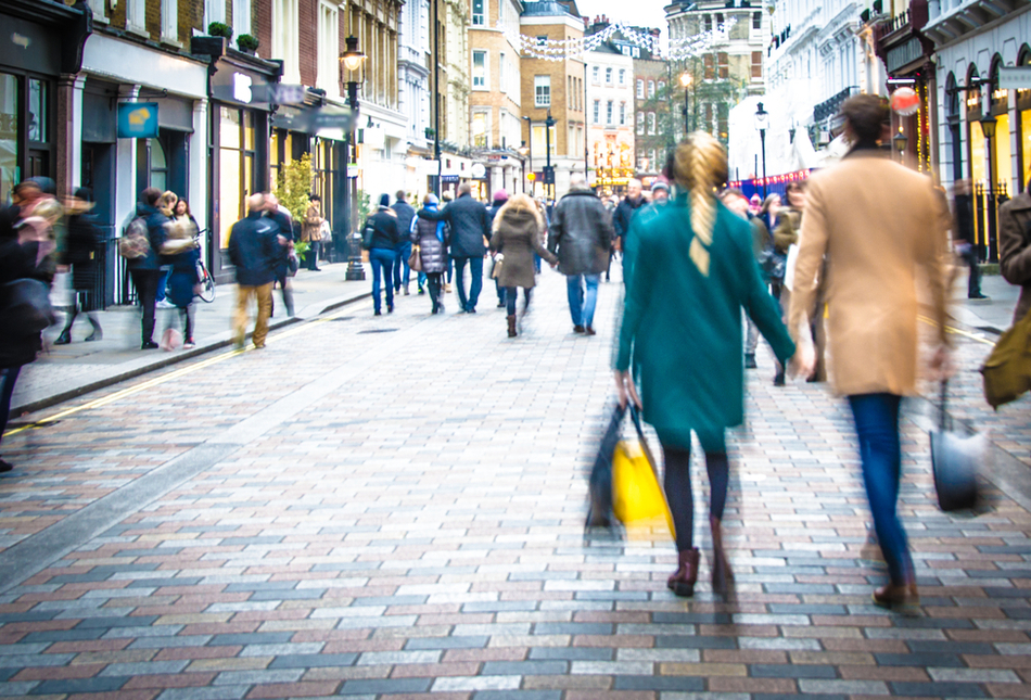 Shoppers walking down a high street.