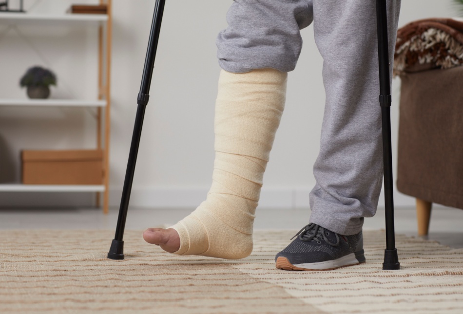 A man with a broken leg using crutches.