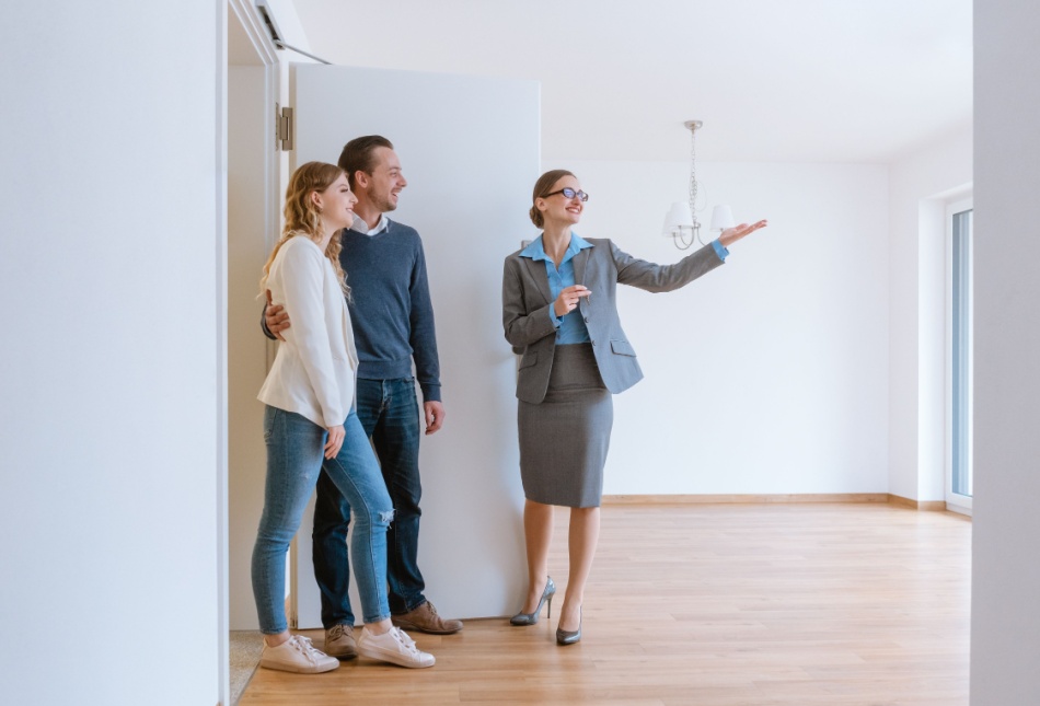 An estate agent showing a couple a property.
