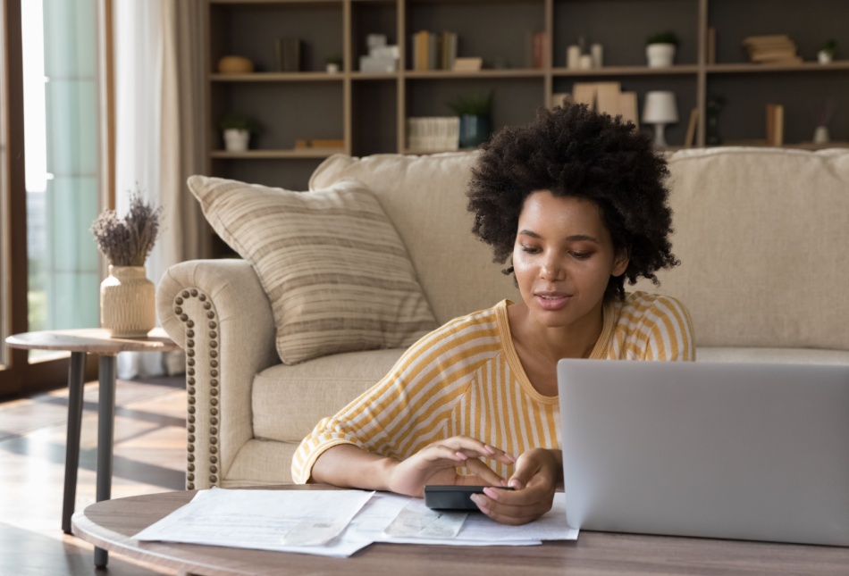 A woman reviewing some paperwork at home.