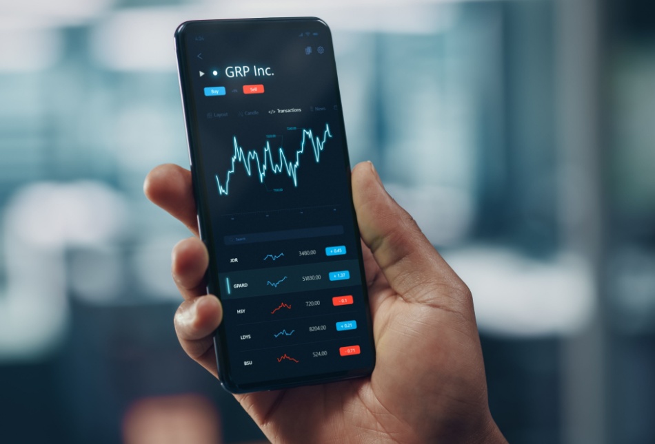 A man looking at stock market performance on his phone.