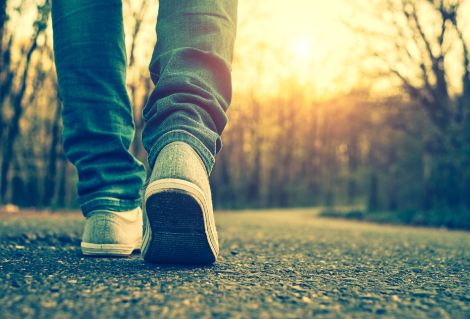 A close-up of someone walking on a path.