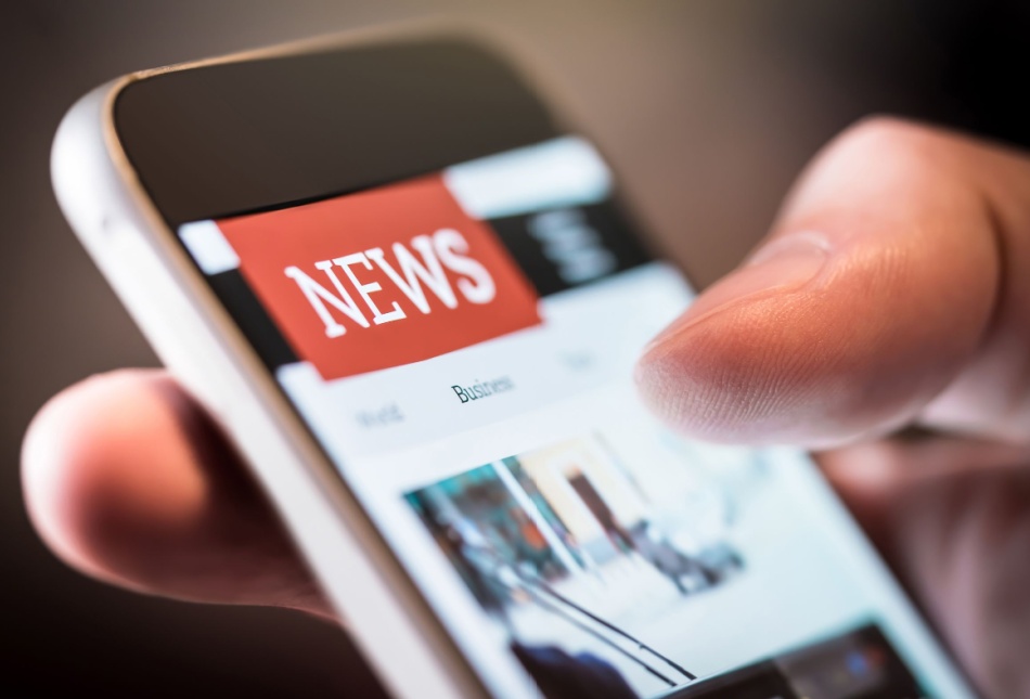 A person using a smartphone to read the news.