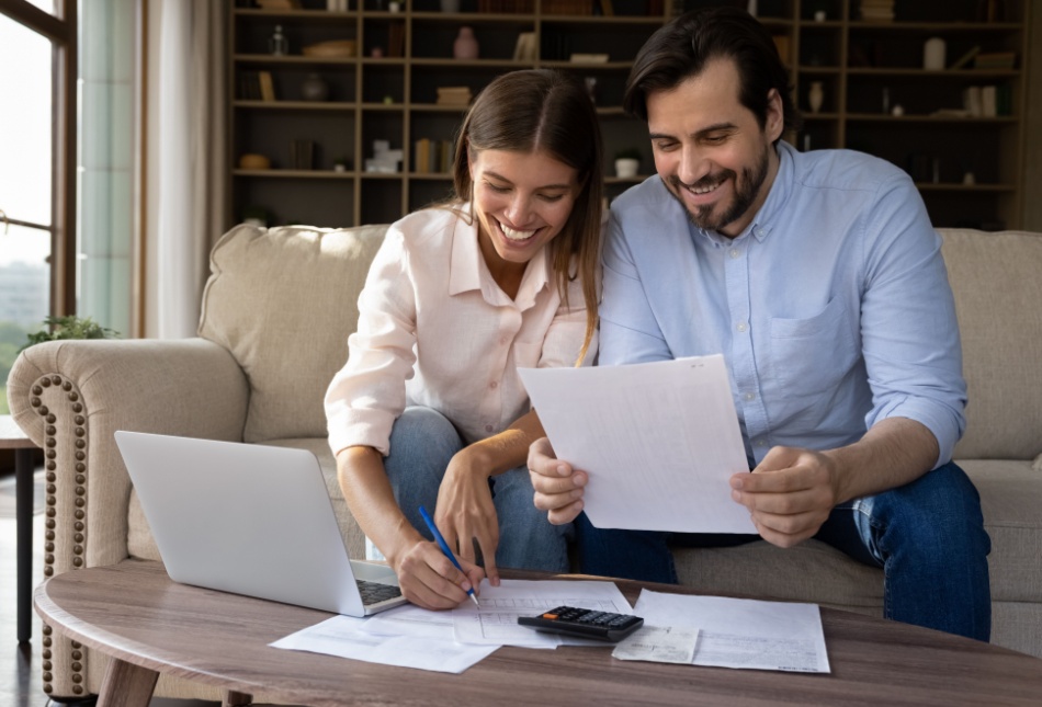 A young couple reviewing paperwork together.