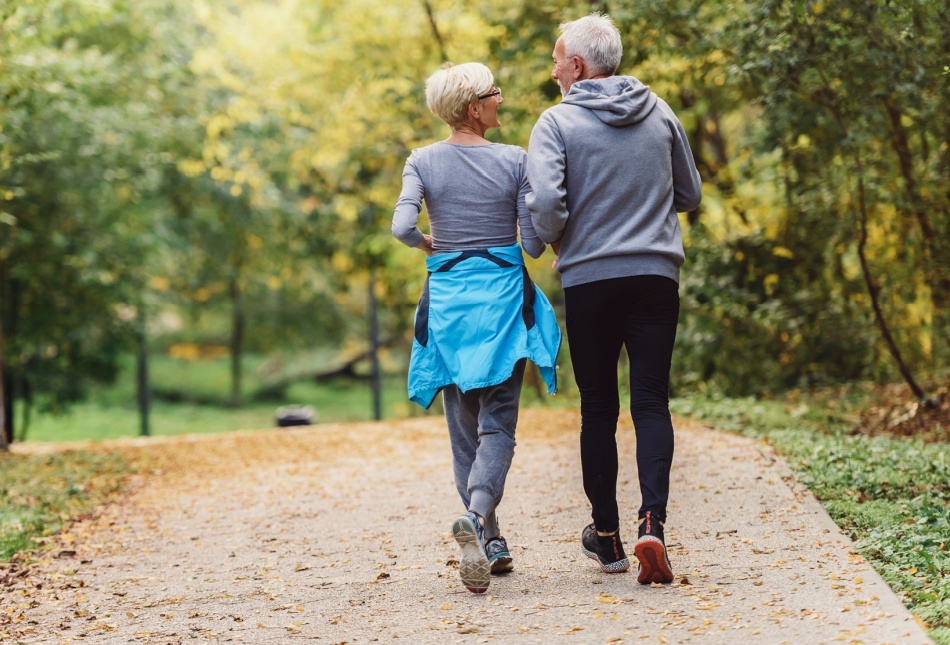 A couple jogging in a park.