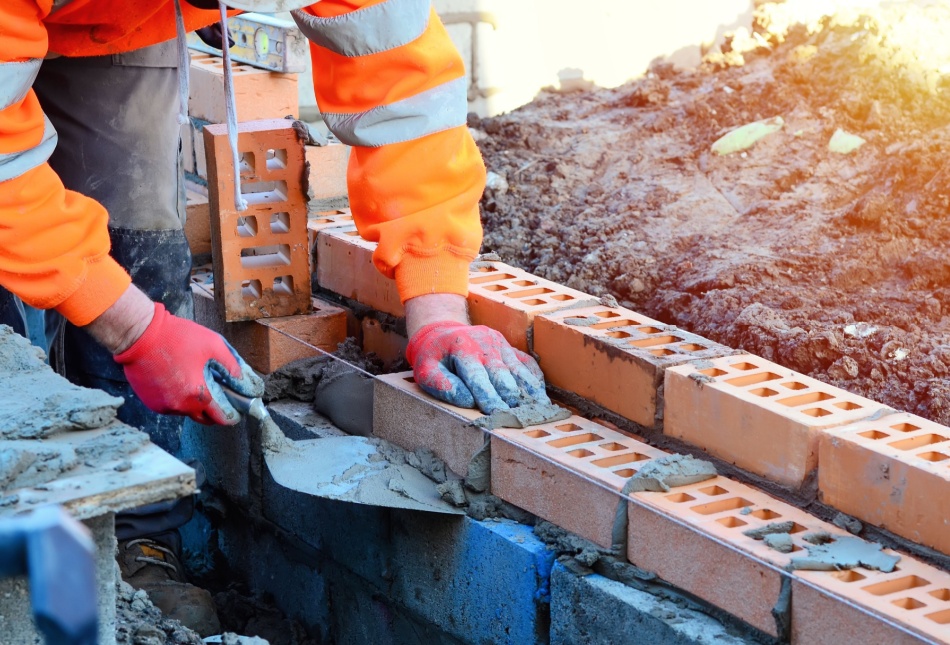 A bricklayer working on a construction site.