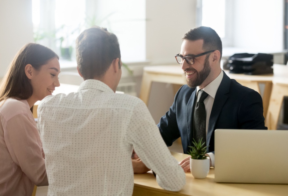 A young couple meeting with a financial planner.