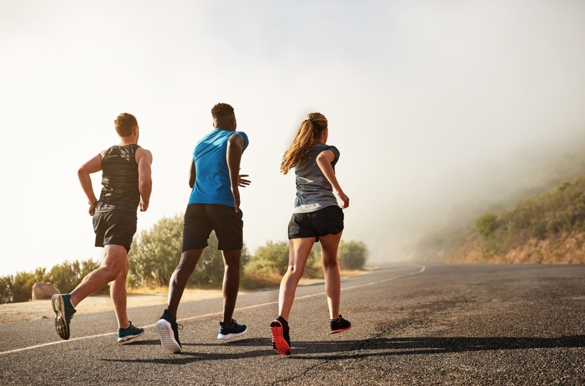Three people running outside.