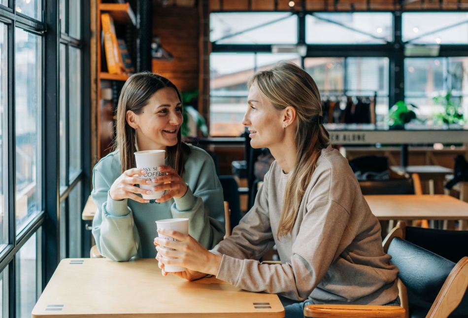 Two women talking in a coffee shop.