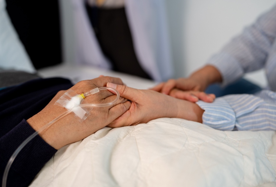 A patient holding hands with a loved one.