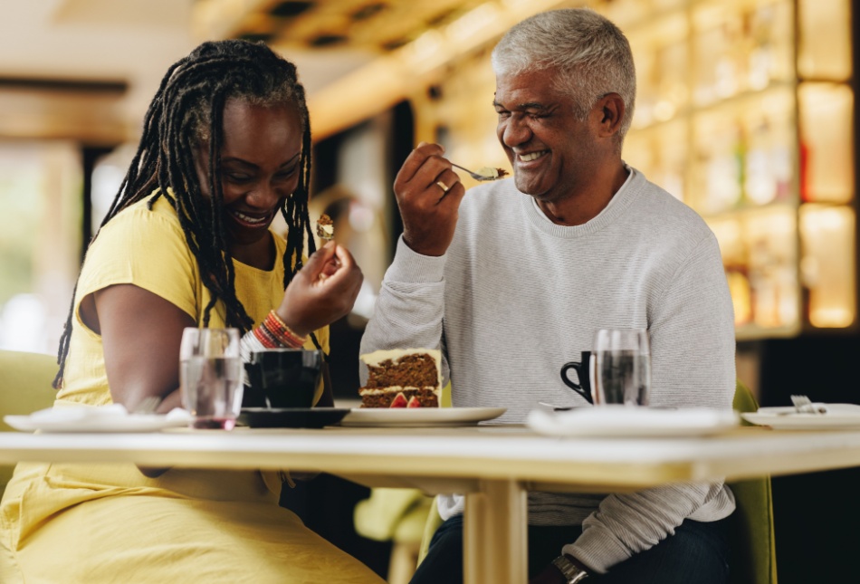A couple laughing together at a café.
