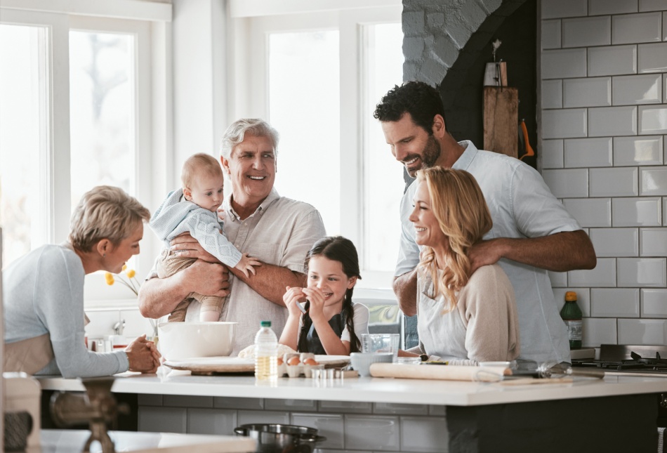Three generations of family cooking in the kitchen