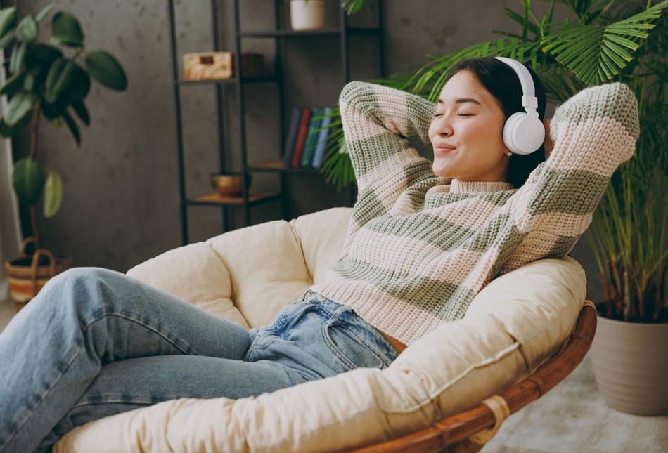 A woman relaxing with headphones on.