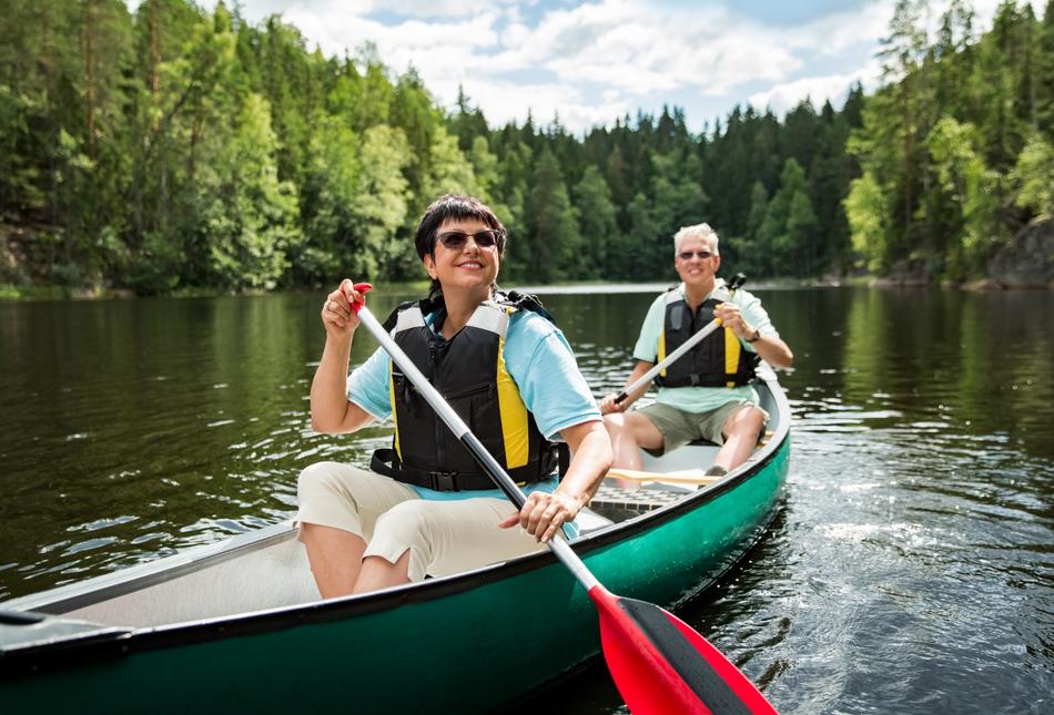 A couple on holiday taking a canoe ride.