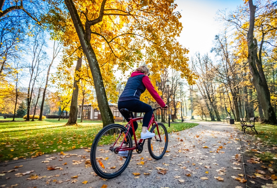A woman cycling in a park.