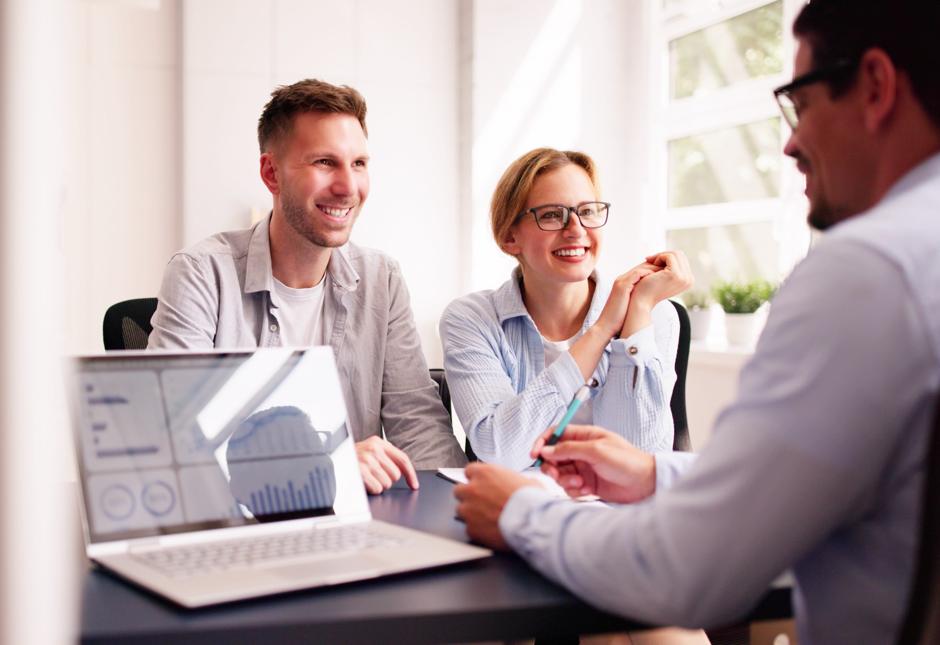 A young couple meeting with a financial planner.