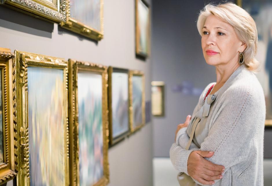 A woman looking at art in a gallery.