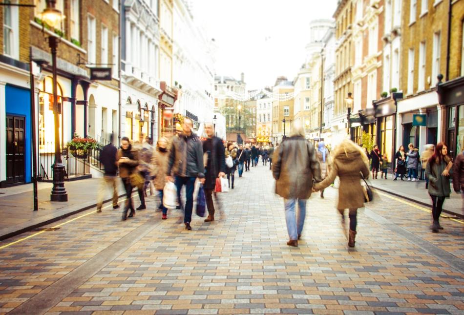 People walking down a high street.