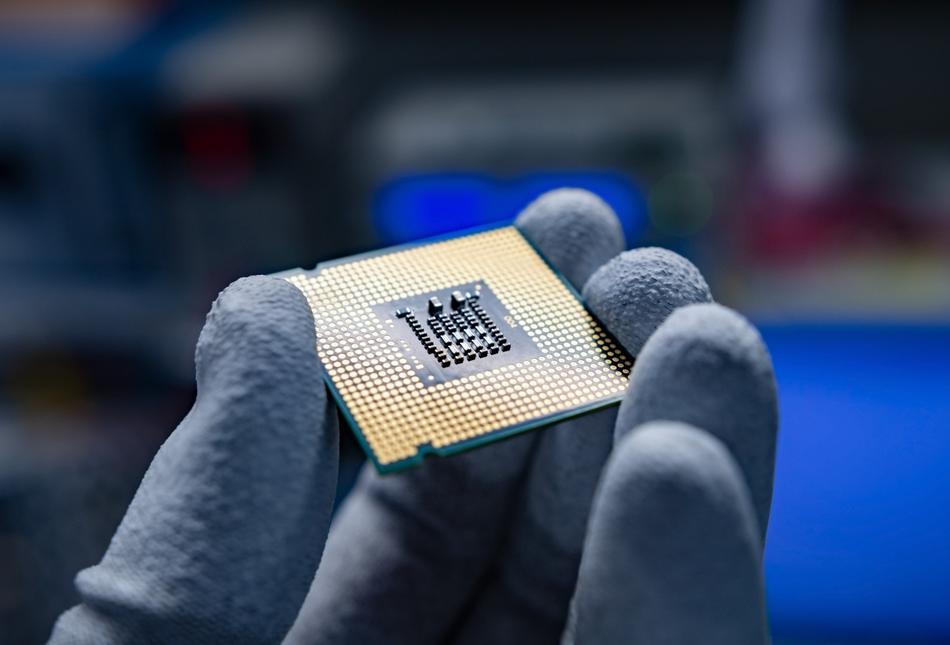 A hand holding a CPU.