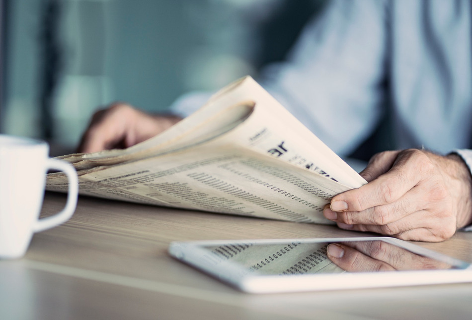 A man reading a newspaper.