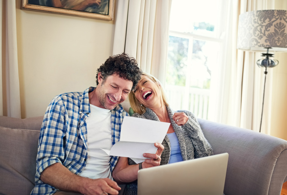 A happy couple reviewing paperwork.