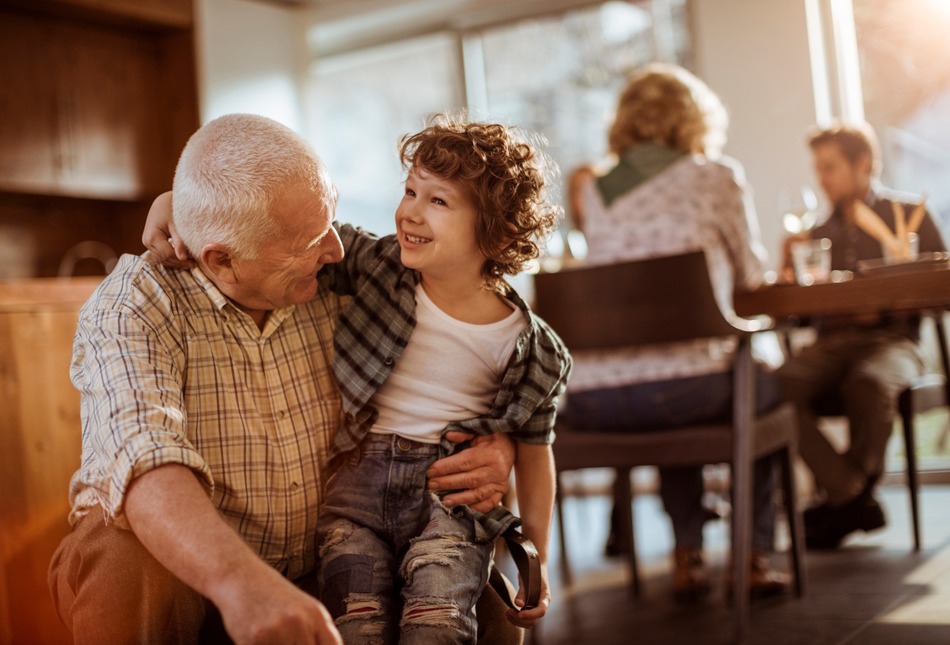 Grandfather hugging his grandchild.