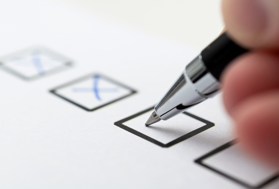 A person checking tick boxes.