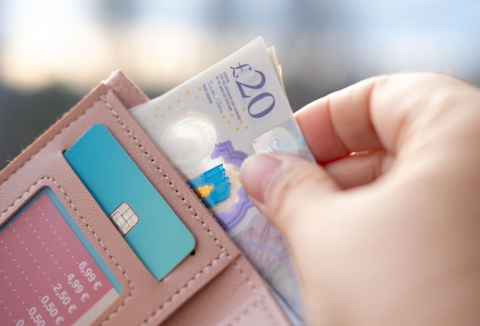 Someone taking money out of a wallet.