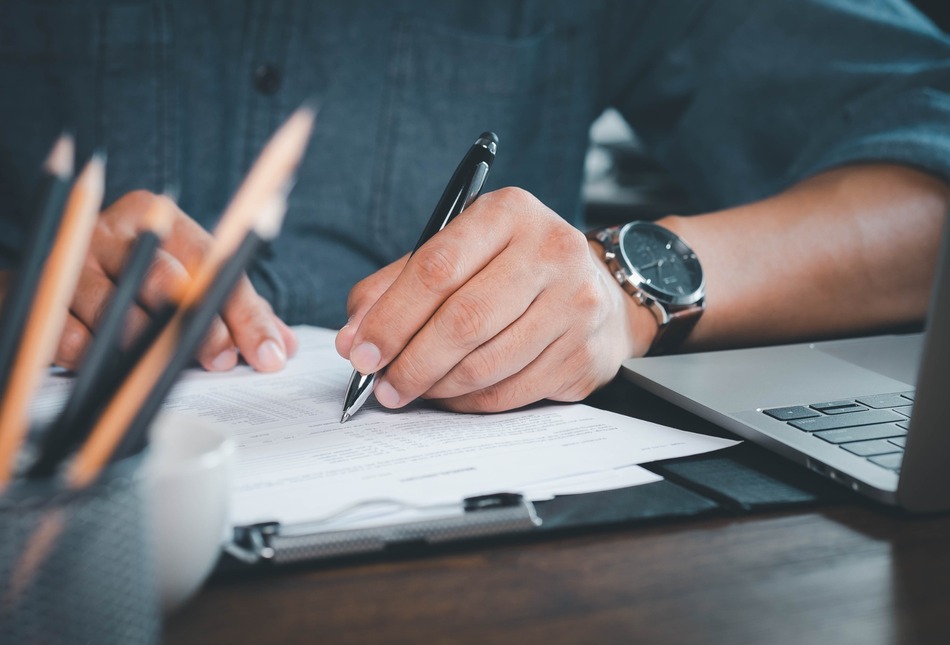 A man making notes on paperwork.