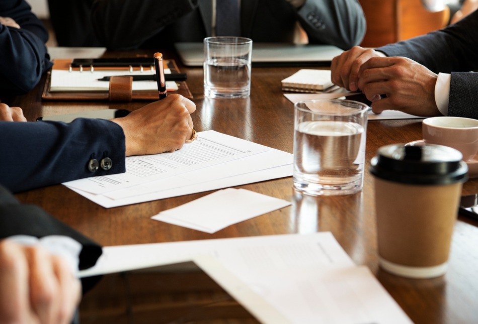 People sitting around a table for a company meeting.