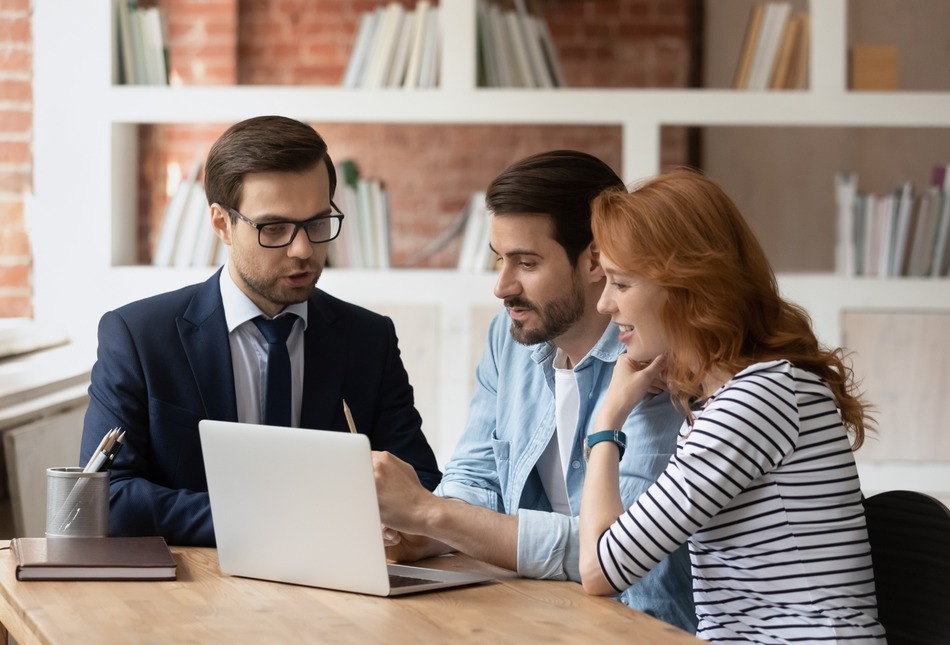 A couple speaking to a mortgage adviser.